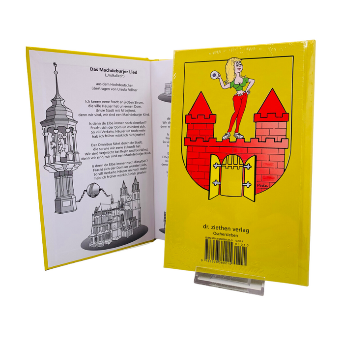 Rückseite des Buches 'Das Machdeburjer Wörterbuch' mit auffälliger gelber Gestaltung, rotem Turmmotiv und einer Cartoonfigur; im Hintergrund geöffnete Buchseite mit Text und Zeichnungen der Magdeburger Architektur. Erhältlich im Magdeburg-Shop.