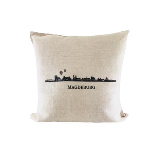 Dekoratives Kissen mit der Skyline von Magdeburg in Schwarz auf cremefarbenem Hintergrund, erhältlich im Magdeburg-Shop.