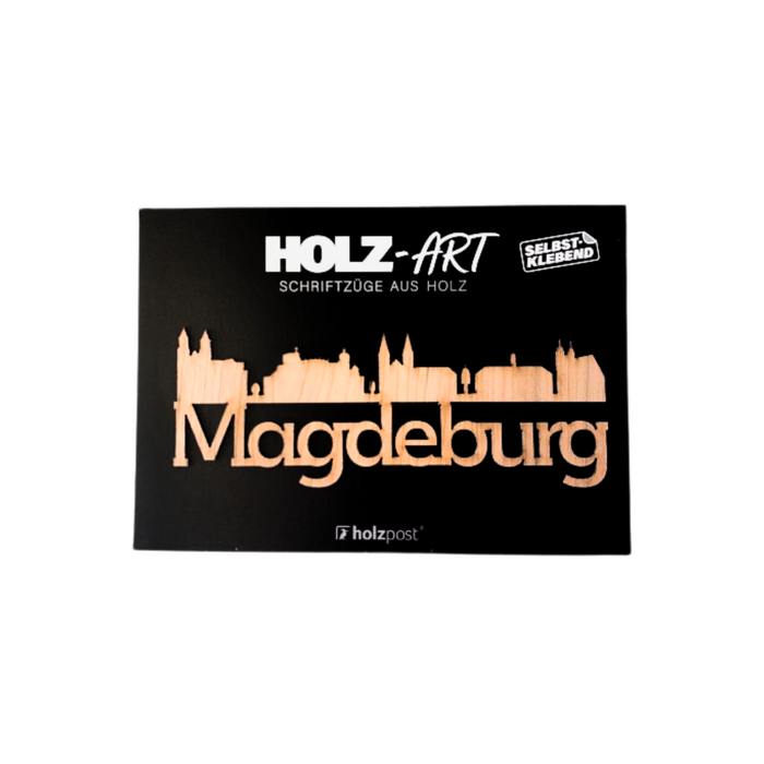 Aufkleber Holz-Skyline mit Schriftzug Magdeburg aus Holz, selbstklebend, vor schwarzem Hintergrund.